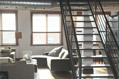 Mid-sized contemporary metal straight staircase in Other with metal risers and metal railing.