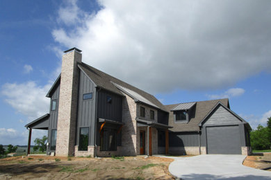 Example of a mid-sized transitional gray two-story wood exterior home design in Dallas with a shingle roof