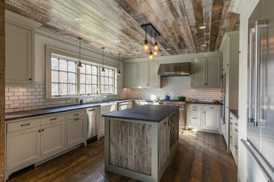 Eat-in kitchen - large country u-shaped dark wood floor eat-in kitchen idea in Boston with a farmhouse sink, recessed-panel cabinets, soapstone countertops, white backsplash, stainless steel appliances, an island, beige cabinets and subway tile backsplash