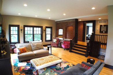 This is an example of a mid-sized transitional living room in Detroit with brown walls, light hardwood floors and brown floor.