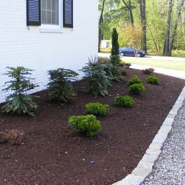 Casual backyard gravel pathway merges with formal front yard bluestone walk