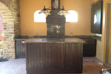 Inspiration for a large mediterranean backyard tile patio kitchen remodel in Orlando with a roof extension