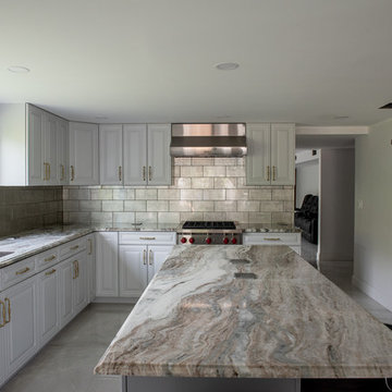 Transitional Kitchen Done in a 2 Tone Color With Integrated Dining Table