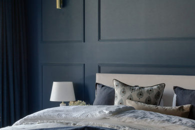 Photo of a large traditional master bedroom in Other with blue walls, laminate floors, brown floors and panelled walls.