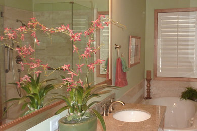 Example of a mid-sized transitional master beige tile and stone tile travertine floor corner shower design in Salt Lake City with an undermount sink, granite countertops, a two-piece toilet and green walls