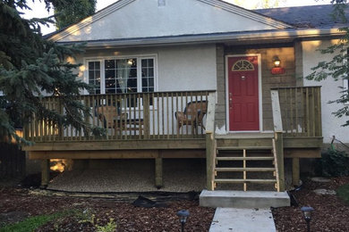 Mid-sized elegant front porch photo in Edmonton with decking