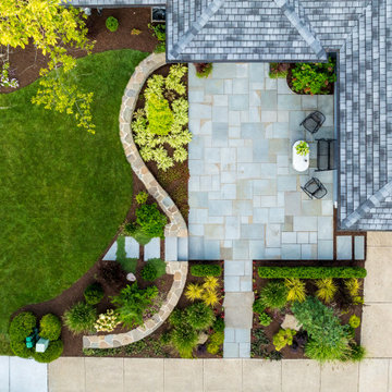 Front courtyard from above: bluestone terrace and curving fieldstone wall