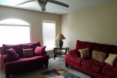 Inspiration for a small contemporary carpeted family room remodel in Raleigh with beige walls and no tv