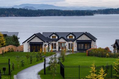 Inspiration for a large transitional white two-story mixed siding exterior home remodel in Vancouver with a metal roof and a black roof