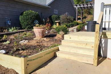 Arts and crafts ground level privacy and wood railing deck container garden photo in Other with no cover