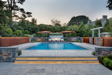 Inspiration for a transitional backyard concrete paver and rectangular pool remodel in Boston