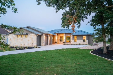 Example of a large transitional one-story mixed siding house exterior design in Austin
