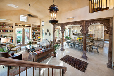 Living room - mediterranean open concept concrete floor living room idea in Denver