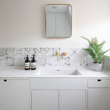 Wall hung taps and patterned splashback tiles