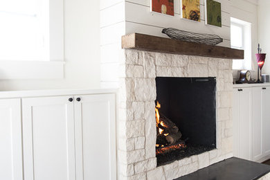 Inspiration for a mid-sized cottage dark wood floor living room remodel in Dallas with a standard fireplace, a stone fireplace and no tv