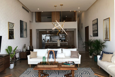 Inspiration for a mid-sized coastal open concept ceramic tile and brown floor living room remodel in Other with white walls and a wall-mounted tv