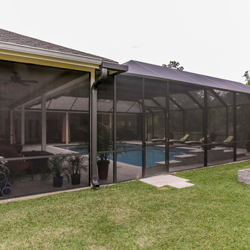 Patio with Fireplace with Screened Pool Enclosure