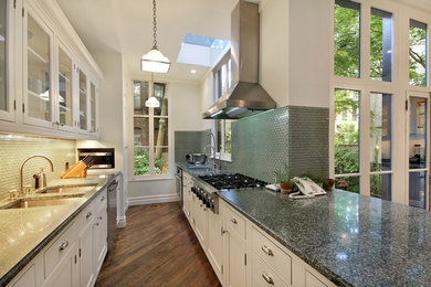 Inspiration for a mid-sized transitional galley dark wood floor eat-in kitchen remodel in New York with a double-bowl sink, recessed-panel cabinets, white cabinets, granite countertops, blue backsplash, glass tile backsplash, stainless steel appliances and a peninsula