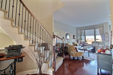 Family room library - mid-sized contemporary open concept medium tone wood floor family room library idea in Ottawa with beige walls, no fireplace and no tv