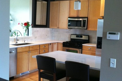 Inspiration for a mid-sized contemporary l-shaped light wood floor eat-in kitchen remodel in Minneapolis with an undermount sink, shaker cabinets, light wood cabinets, quartz countertops, white backsplash, stone tile backsplash, stainless steel appliances and an island