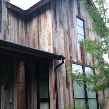 Vertical wood siding with modern metal roof