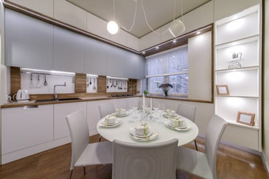 Photo of a mid-sized contemporary u-shaped separate kitchen in Moscow with flat-panel cabinets, white cabinets and solid surface benchtops.