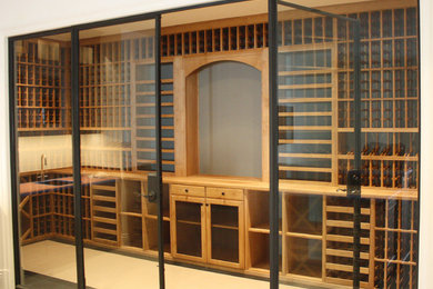 Example of a mid-sized trendy porcelain tile wine cellar design in Los Angeles