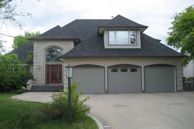 Inspiration for a large timeless beige two-story mixed siding exterior home remodel in Other with a shingle roof