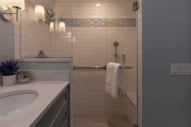 Powder room - mid-sized transitional multicolored tile and subway tile multicolored floor powder room idea in Chicago with shaker cabinets, blue cabinets, a two-piece toilet, gray walls, an undermount sink, quartz countertops, white countertops and a built-in vanity