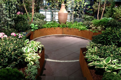 This is an example of a small transitional shade courtyard landscaping in Providence for spring.