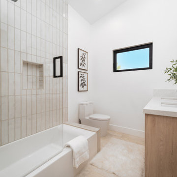 Guest Bath with Stacked Vertical Tile and Oak Vanity