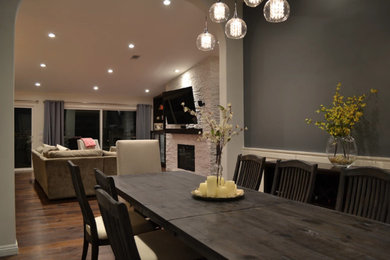 Large trendy dark wood floor and brown floor enclosed dining room photo in Los Angeles with gray walls and no fireplace