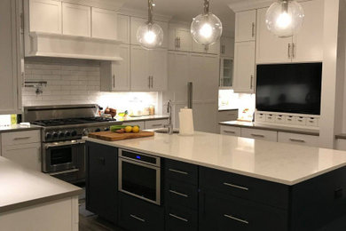 Inspiration for a large farmhouse l-shaped eat-in kitchen remodel in Seattle with shaker cabinets, blue cabinets, granite countertops, subway tile backsplash, stainless steel appliances, an island and white countertops