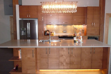 Mid-sized minimalist galley medium tone wood floor eat-in kitchen photo in Milwaukee with an undermount sink, flat-panel cabinets, medium tone wood cabinets, quartz countertops, beige backsplash, glass tile backsplash, stainless steel appliances and an island