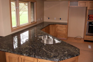 Example of a kitchen design in Other with an undermount sink and granite countertops