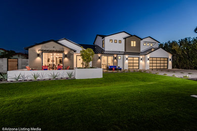 Example of a large minimalist beige two-story mixed siding house exterior design in Phoenix