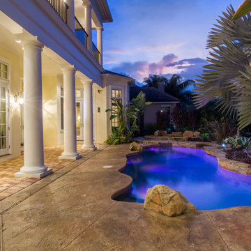 Resort style pool with lake and golf course view.
