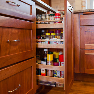 Traditional kitchen pantry designs - Example of a classic u-shaped medium tone wood floor kitchen pantry design in Portland with flat-panel cabinets, medium tone wood cabinets, an island, an undermount sink, quartz countertops, white backsplash, ceramic backsplash and white appliances