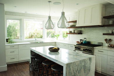 Transitional open plan kitchen in Vancouver with shaker cabinets, white cabinets, marble benchtops, white splashback, stone tile splashback, dark hardwood floors and with island.