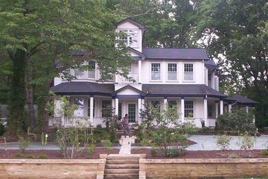 Large traditional three-storey white exterior in Cleveland with wood siding and a hip roof.
