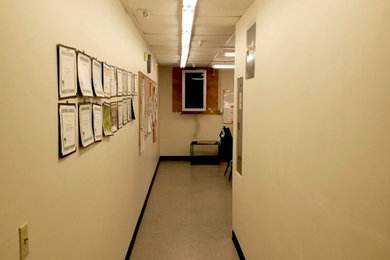 Example of a large minimalist laminate floor and beige floor hallway design in Las Vegas with beige walls