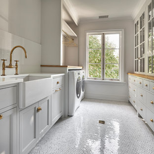 Inspiration for a traditional utility room in New York with glass worktops and marble flooring.
