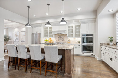 Example of a large transitional home design design in Denver