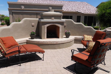 Inspiration for a mid-sized backyard patio remodel in Phoenix with a fire pit