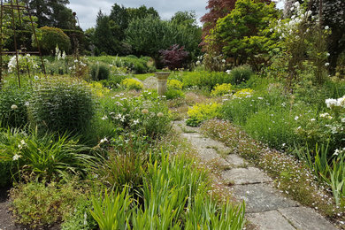 Design ideas for a small rural back full sun garden for summer in Hampshire with a flowerbed and natural stone paving.