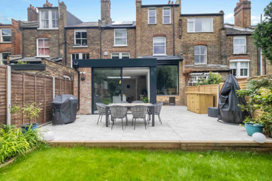 Photo of a contemporary back patio in London with concrete paving.