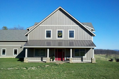 Example of a country gray two-story wood exterior home design in Other