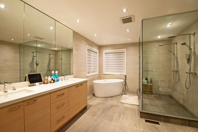 Example of a trendy white tile and porcelain tile porcelain tile bathroom design in Toronto with an undermount sink, flat-panel cabinets, light wood cabinets, quartz countertops and a one-piece toilet