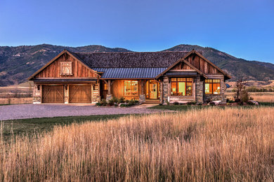 Example of a mid-sized mountain style brown one-story wood exterior home design in Other with a mixed material roof