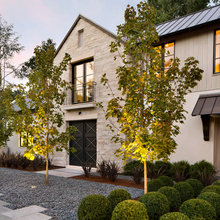 cool white stone with white wood and dark roof